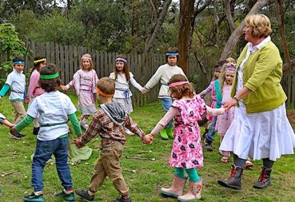 Kindergarten children sing a morning circle.